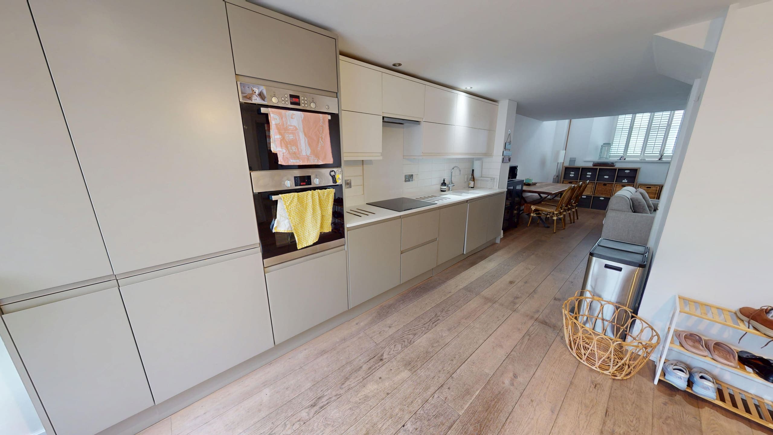 Sleek handleless kitchen renovation with integrated appliances and stone worktop, Brighton