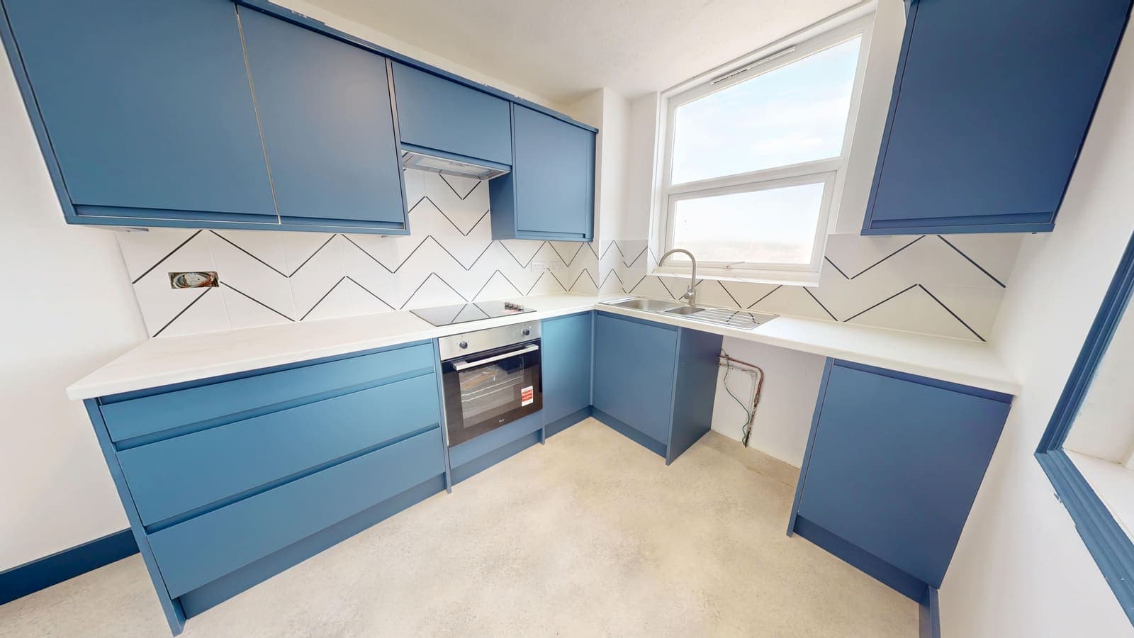 Navy blue kitchen fitting with herringbone splashback, Chartwell Place Brighton