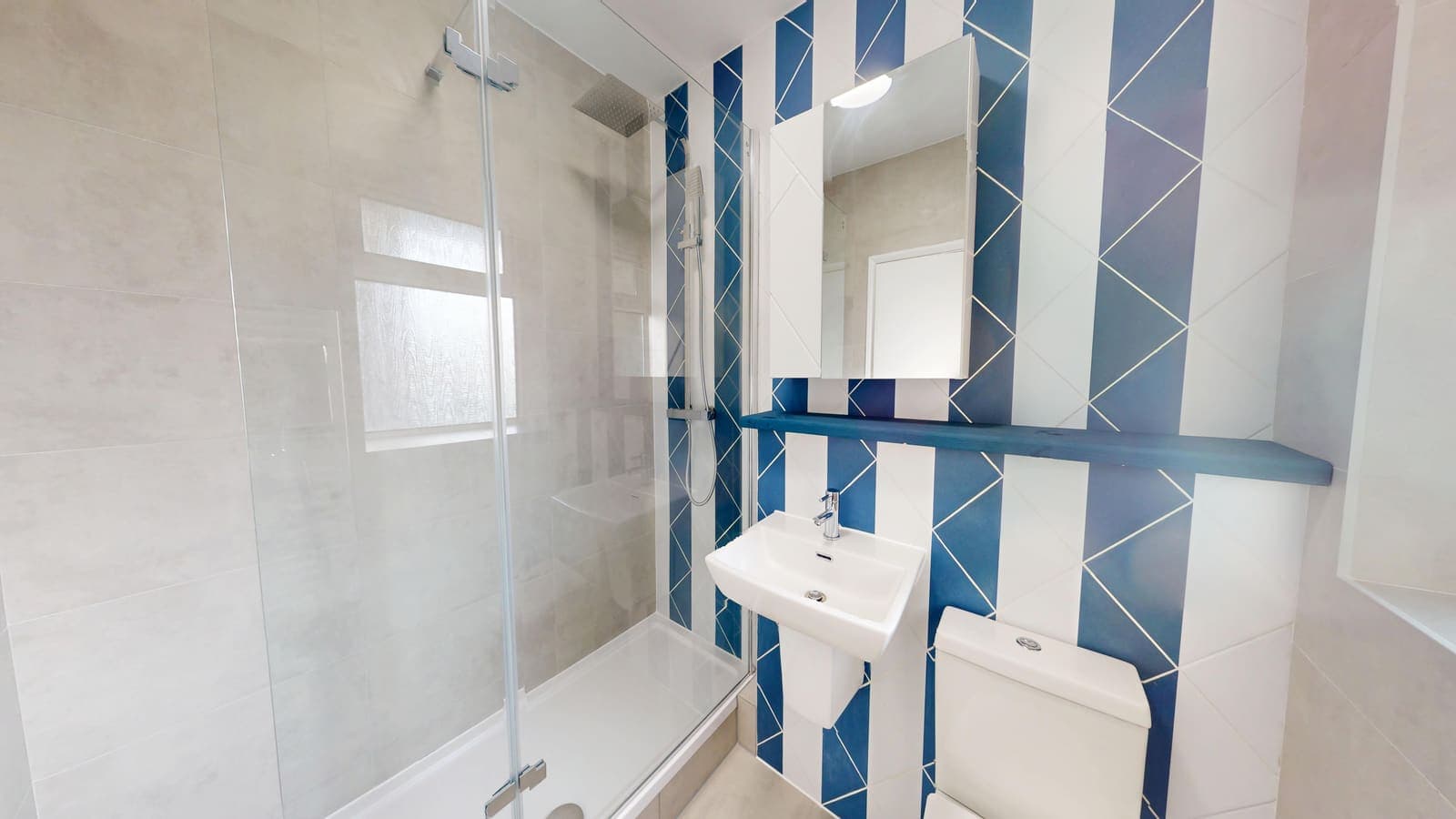 Renovated bathroom with blue feature tiles and white suite, Coniston Court Hove