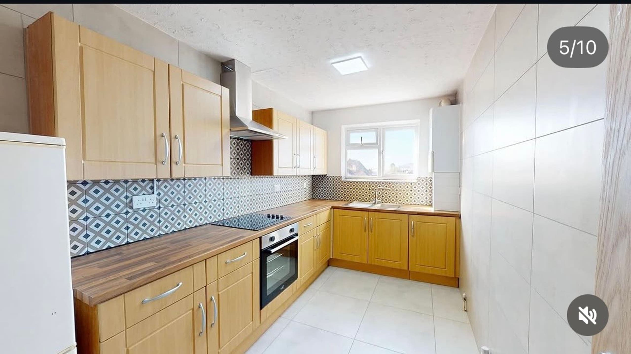 Renovated kitchen with oak units, timber worktop and patterned splashback, Derby Court