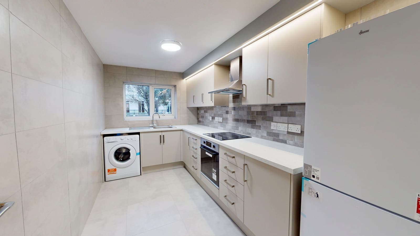 Fitted white kitchen with brick-effect splashback and new appliances, Heather Court