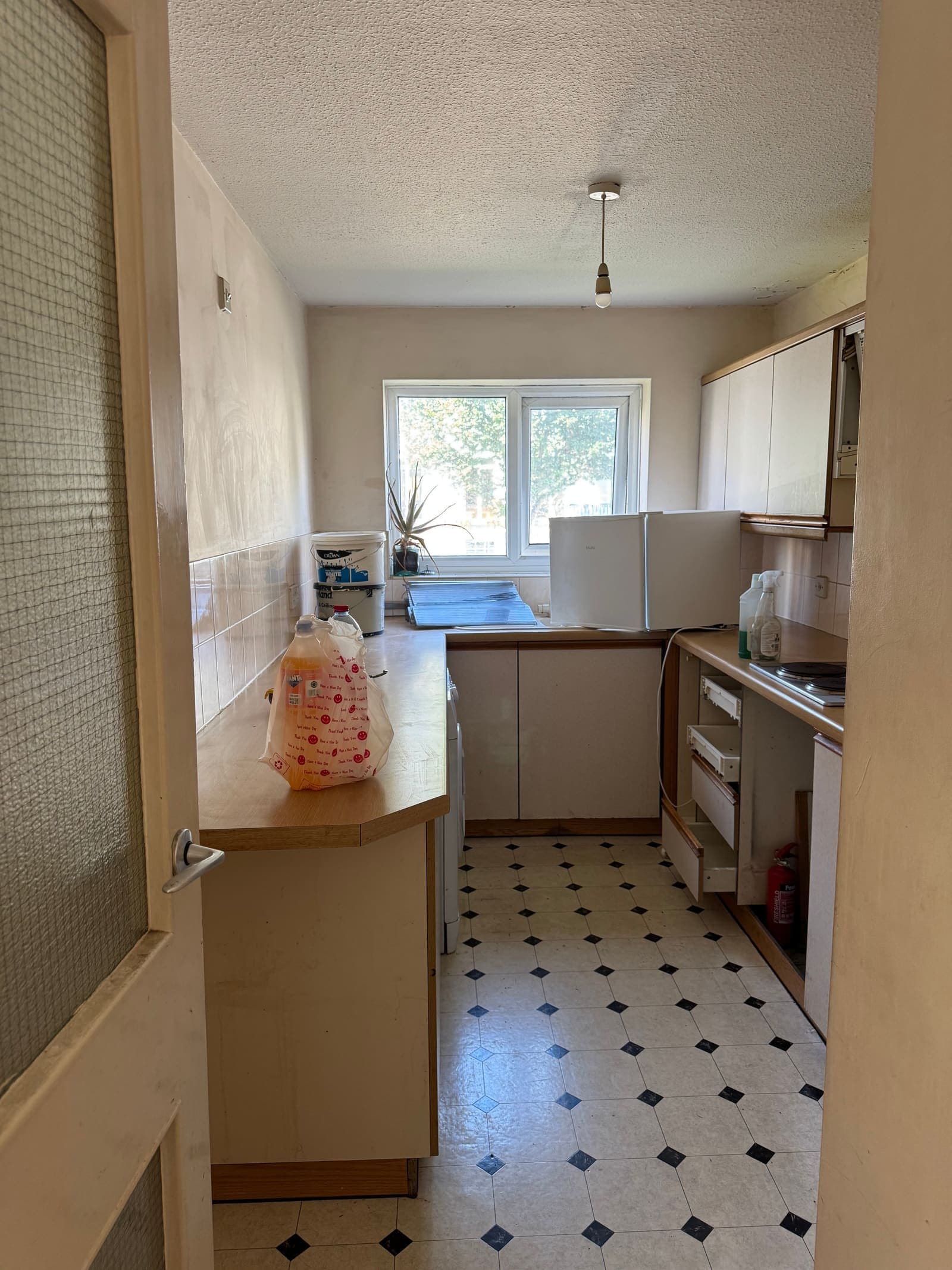 Dated galley kitchen with old oven and worn flooring before renovation, Heather Court Brighton