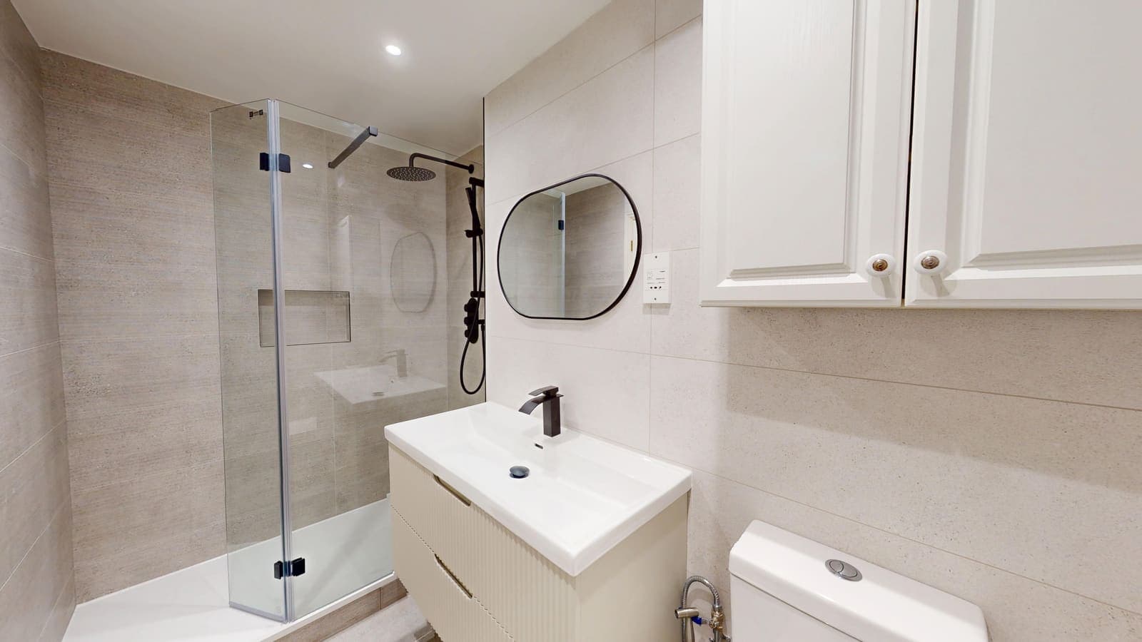 Compact shower room renovation with glass enclosure and white vanity unit in Hove