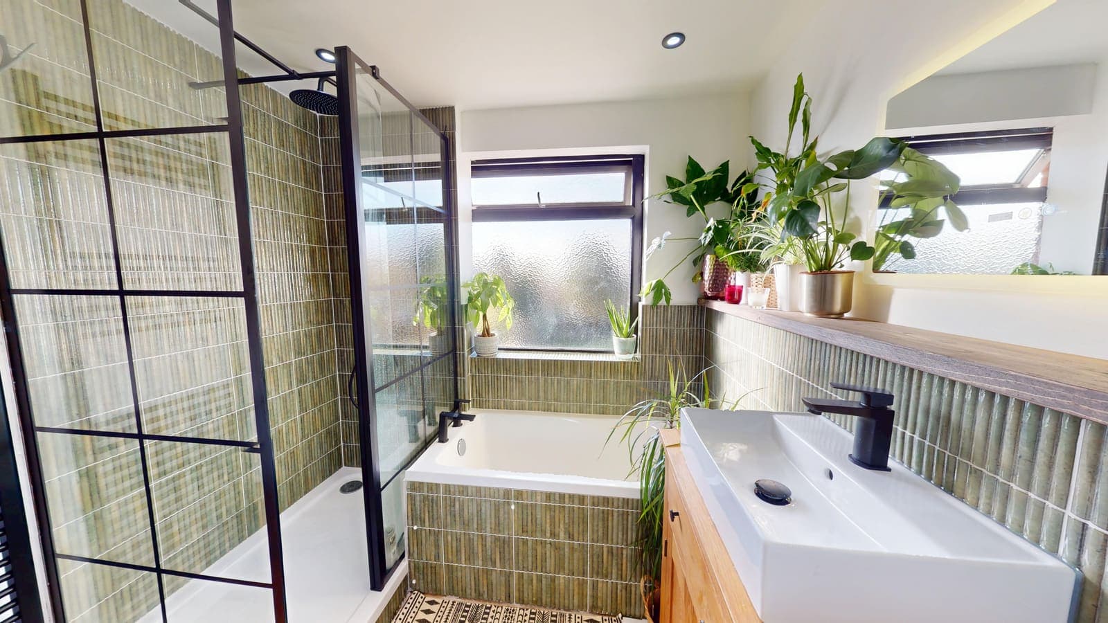 Green-tiled bathroom renovation with black-framed shower screen and bespoke vanity, Phoenix Way