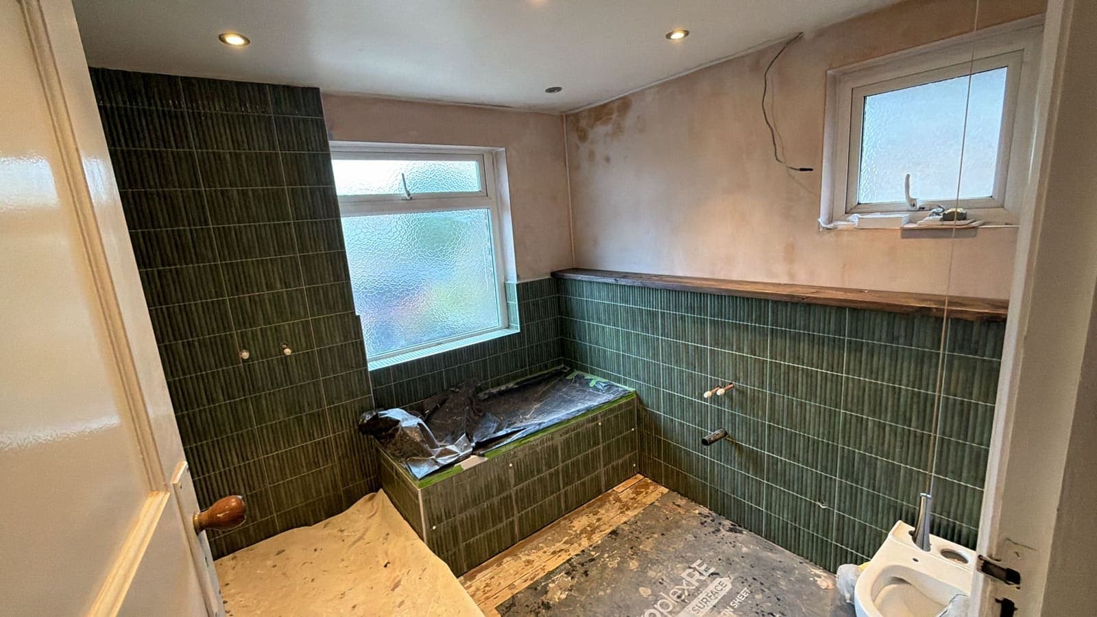Old bathroom with dated dark green wall tiles before renovation, Phoenix Way