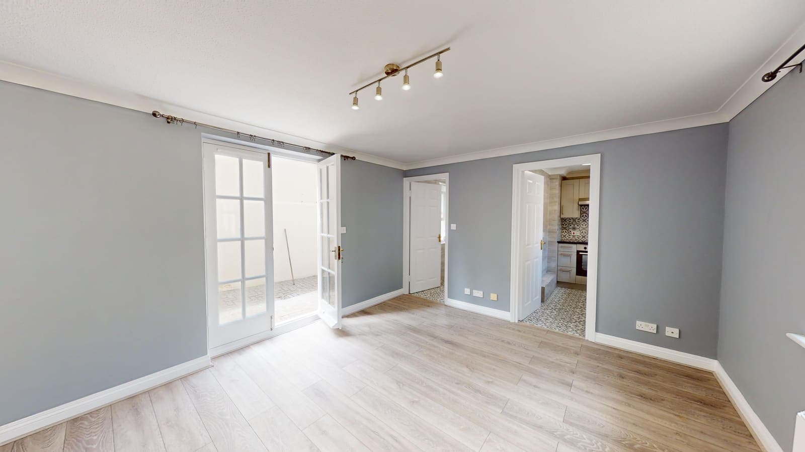 Renovated living room with French doors and fresh grey decoration, Russell Mews