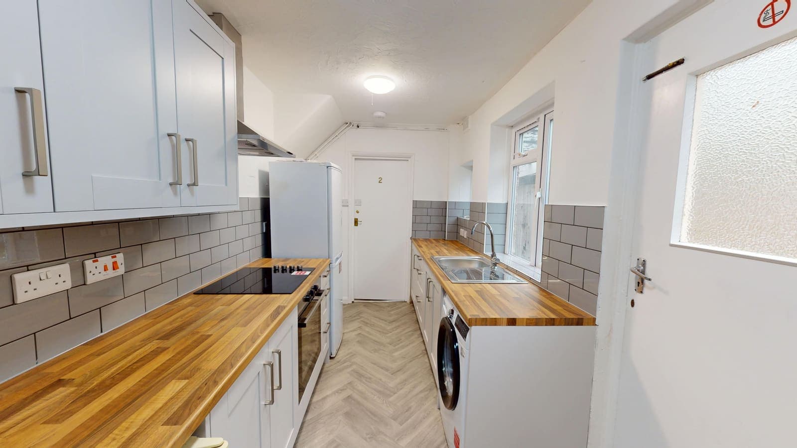 Grey brick-tile kitchen renovation with solid wood worktops, The Avenue Brighton