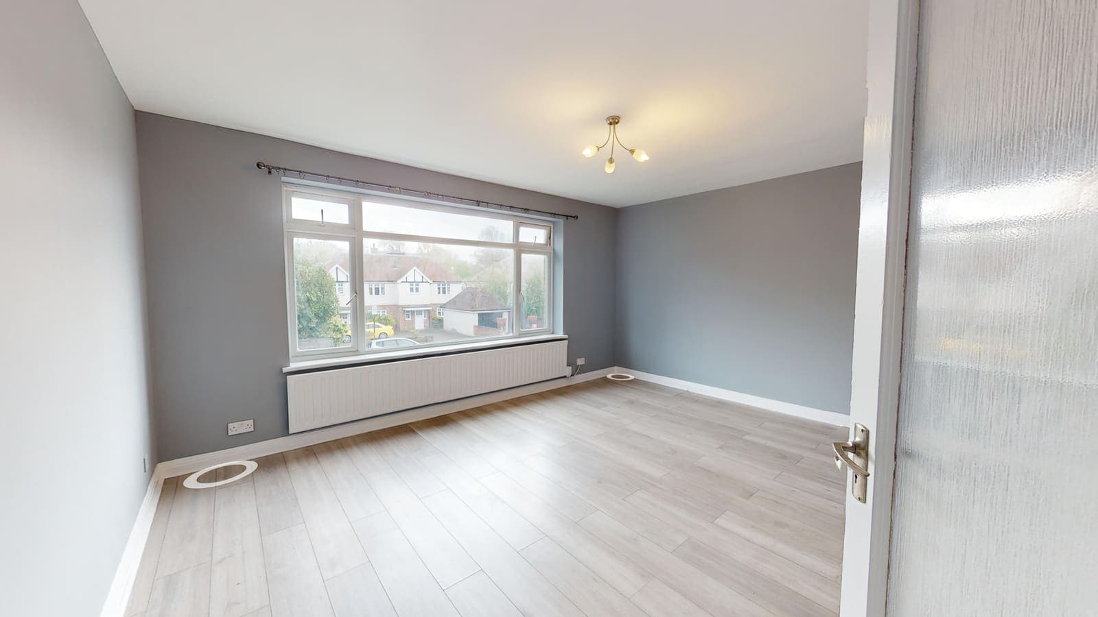 Redecorated living room with grey feature wall and new laminate flooring, Warwick Court