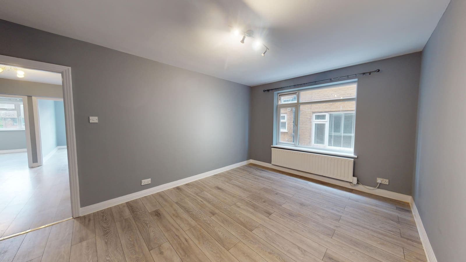 Bright corner living room with full-height windows after refurbishment, Warwick Court Brighton