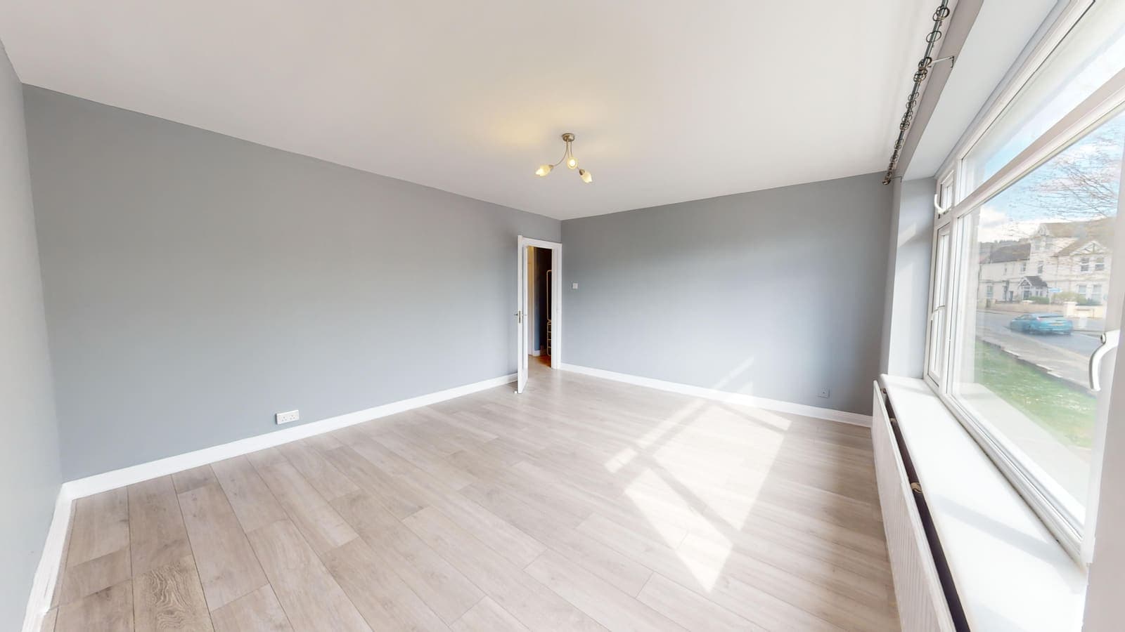 Golden-hour view of a renovated living space with bay windows, Warwick Court